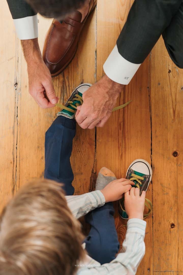 Aerial view of the groom tying his young nephew’s shoes before the ceremony at an intimate Lisbon micro-wedding.