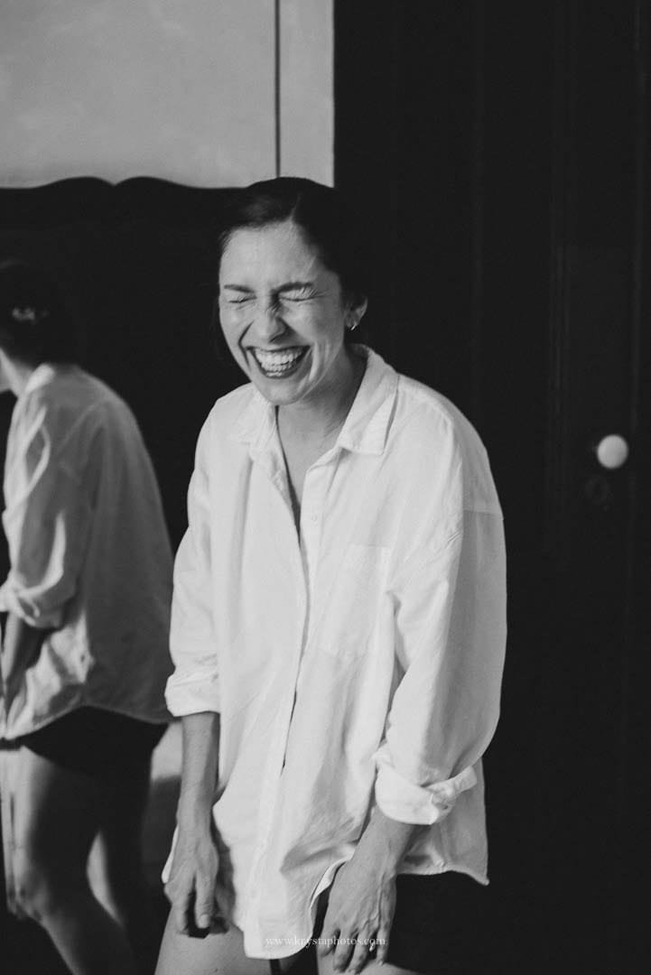 Bride bursting into laughter while getting ready for her intimate Lisbon micro-wedding.