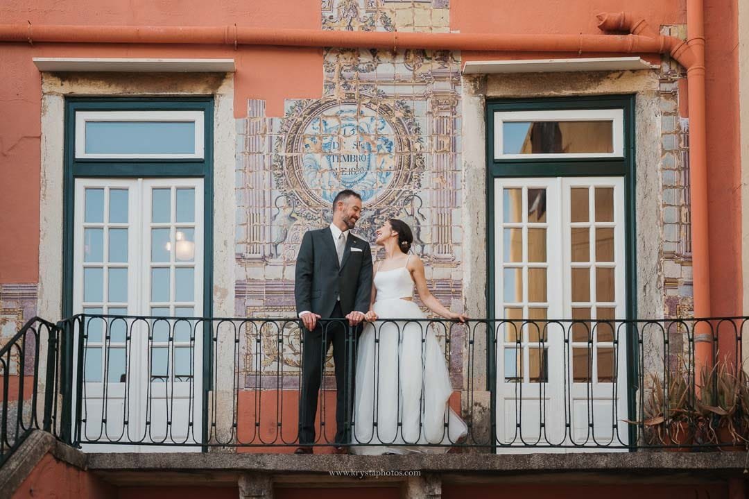 Bride and groom posing in front of traditional Portuguese blue tiles during their intimate Lisbon micro-wedding.