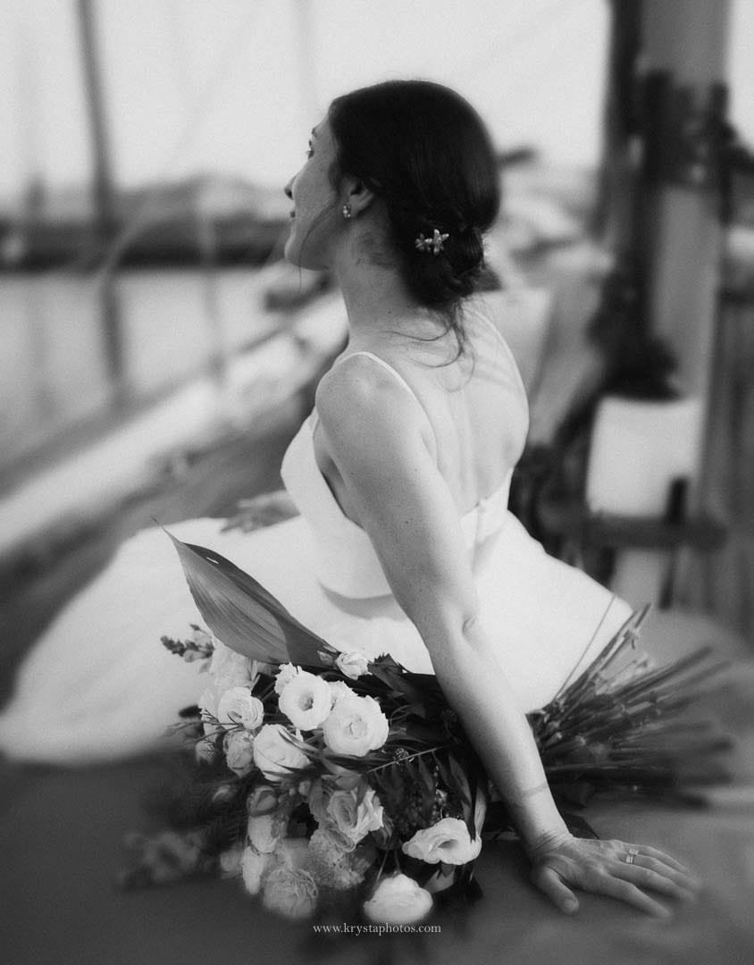 Bride and groom enjoying a cheese and cold cuts board with bubbly on a sailboat during their sunset cruise in Lisbon.