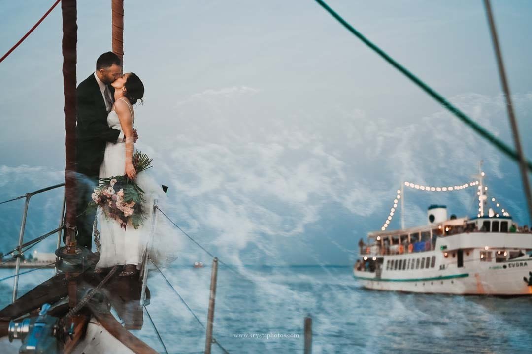Bride and groom sailing on the Tagus River in Lisbon at sunset during their intimate elopement