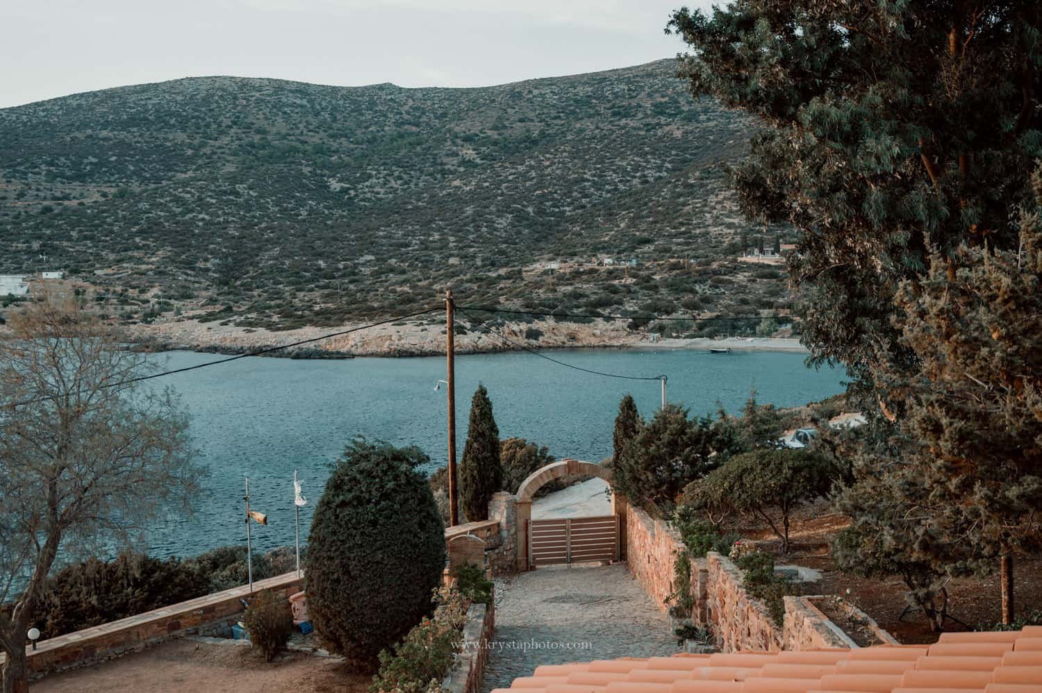 Happy gay couple smiling at each other on a sunny beach in Milos, Greece