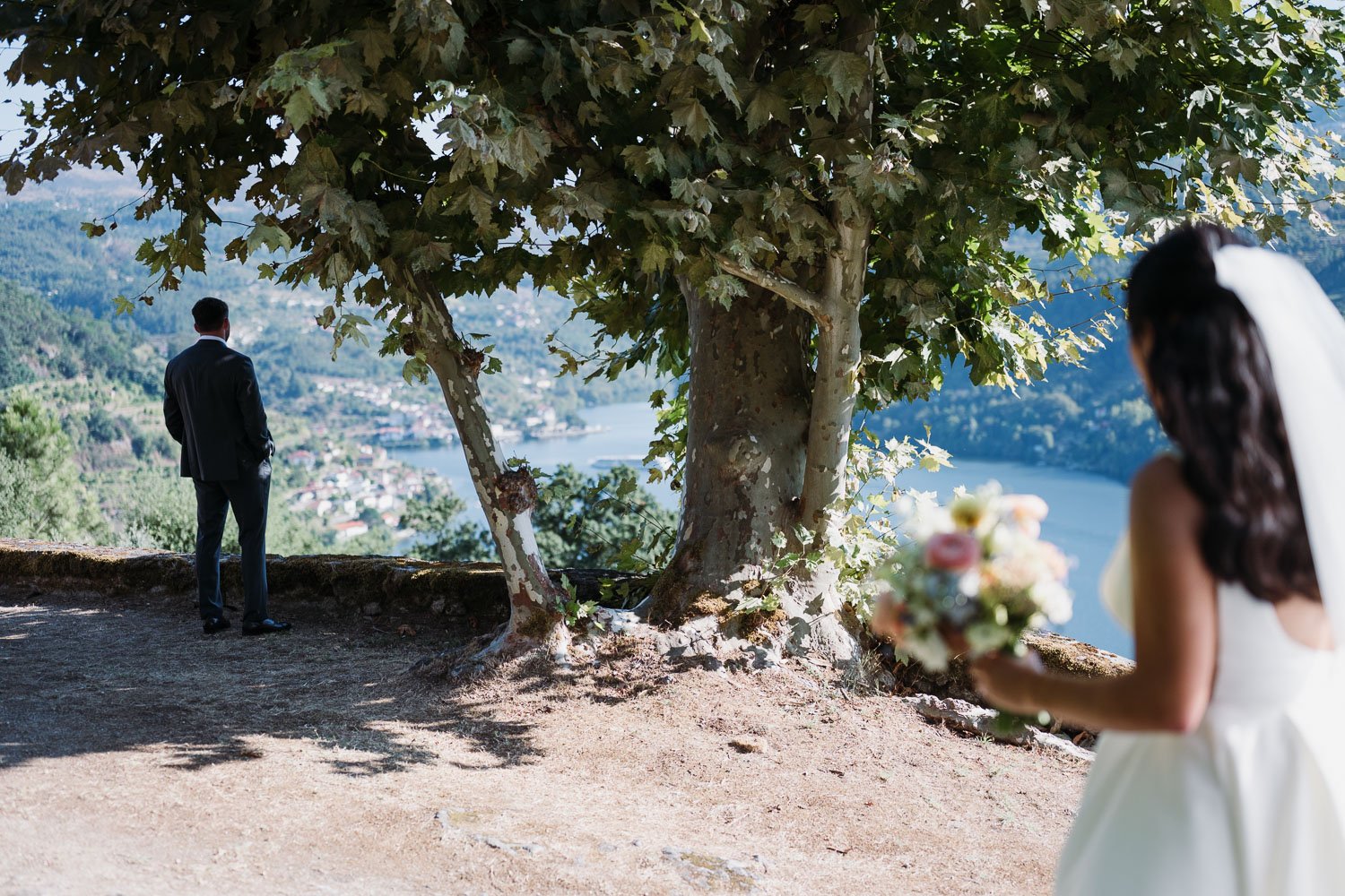 Bride approaching groom for their first look overlooking the Douro River during an intimate Douro Valley wedding