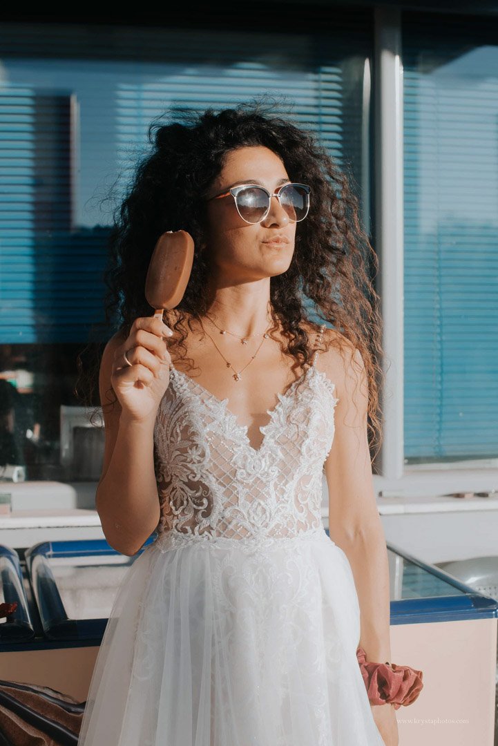 Couple kissing at sunset overlooking the whitewashed village of Myrina, Greece during a romantic engagement session