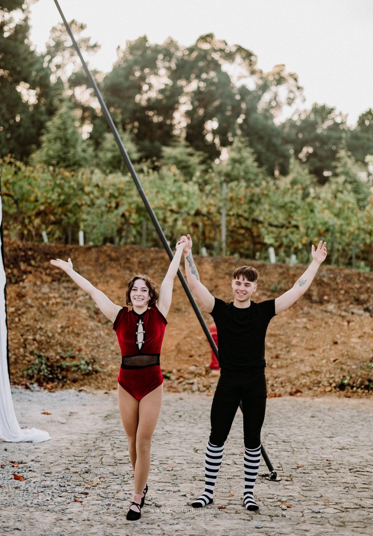 Couple performing aerial circus act after whimsical vineyard wedding reception in Portugal