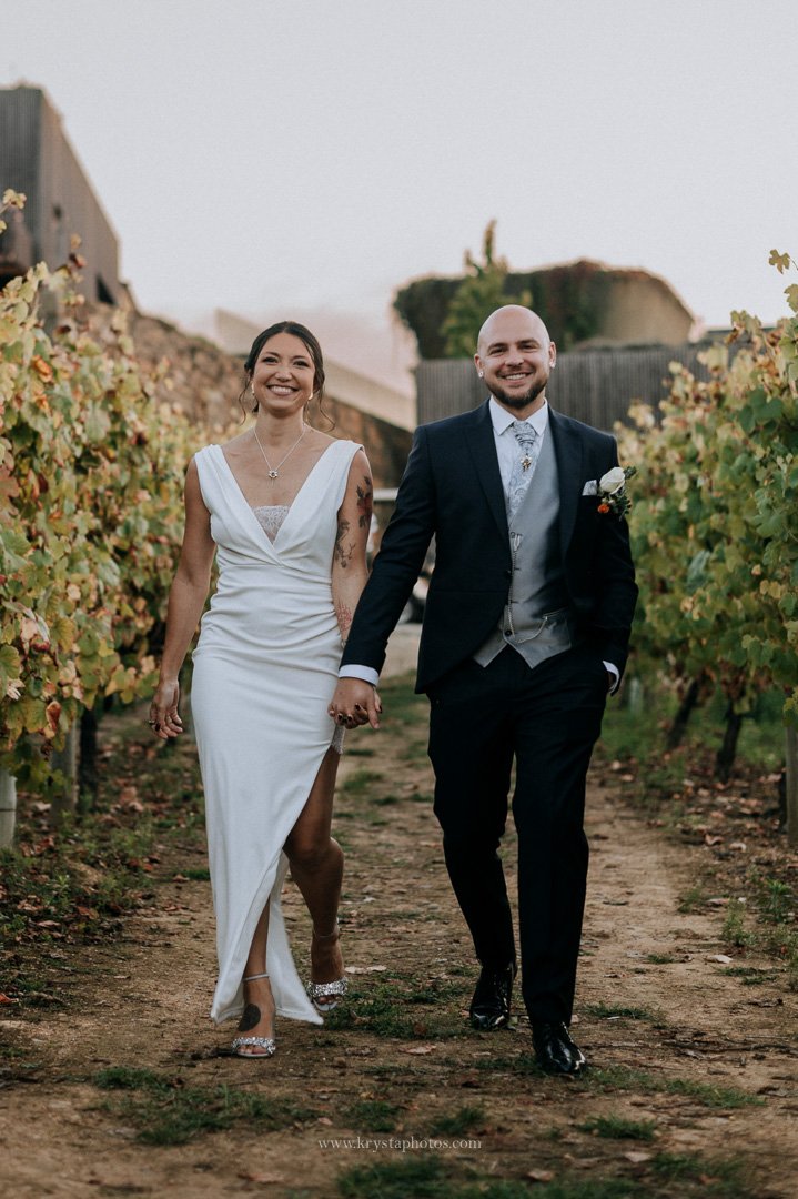 Magical fairy light dinner setup surrounded by vineyards with glowing lightbulbs at a whimsical Portugal wedding