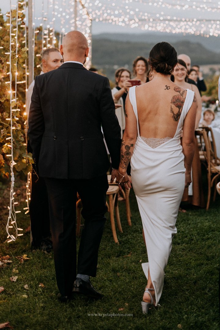 Close-up of Portuguese wine being poured into a glass at a whimsical vineyard wedding reception
