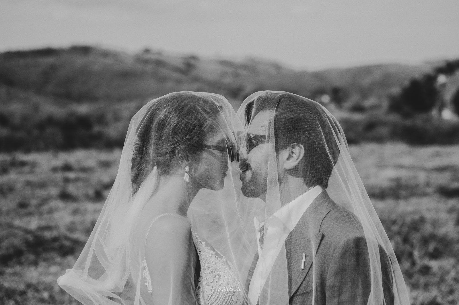 Romantic editorial wedding couple looking at the moon during golden hour in Portugal
