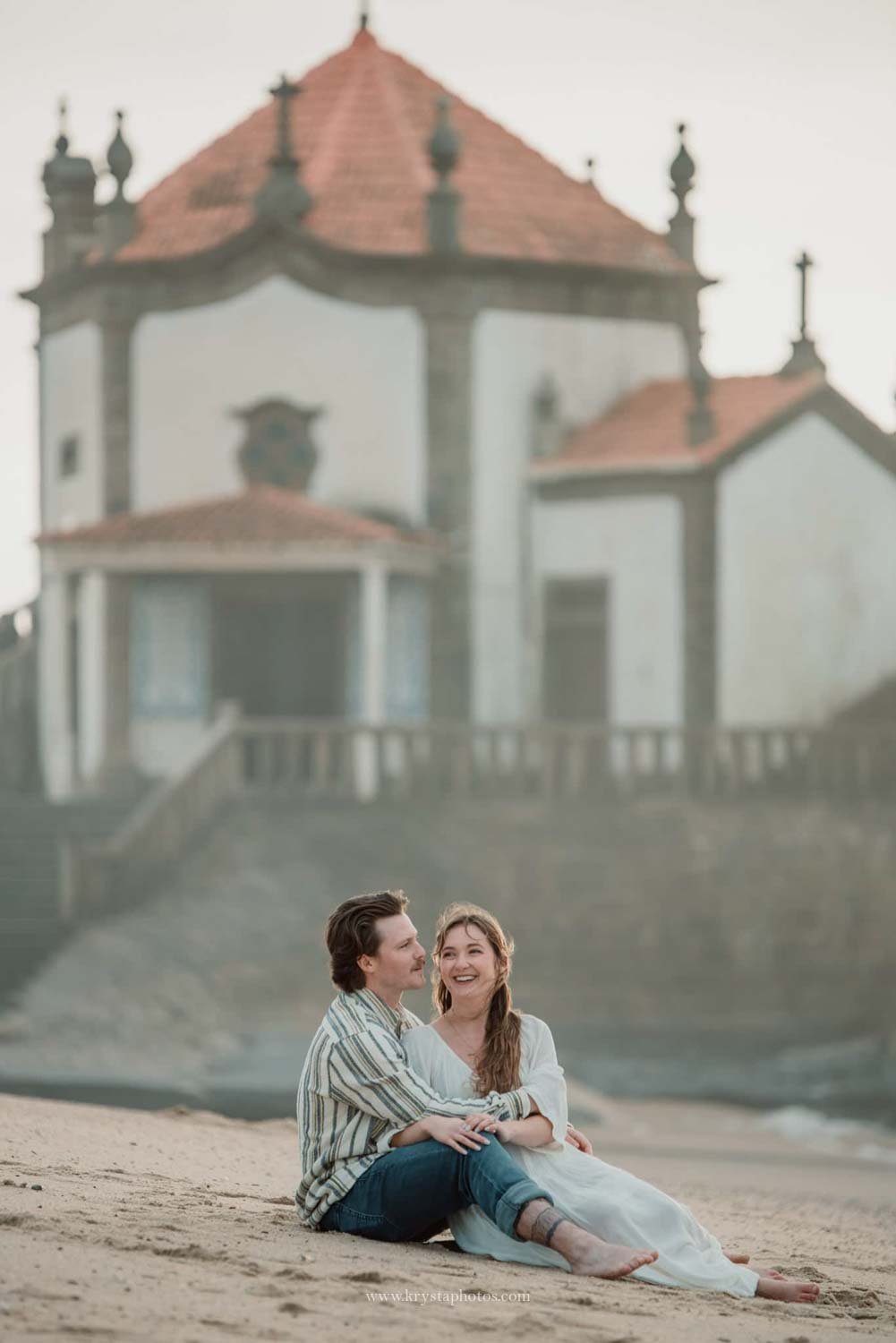 couple photoshoot at Senhor da Pedra Miramar during golden hour with ocean and chapel
