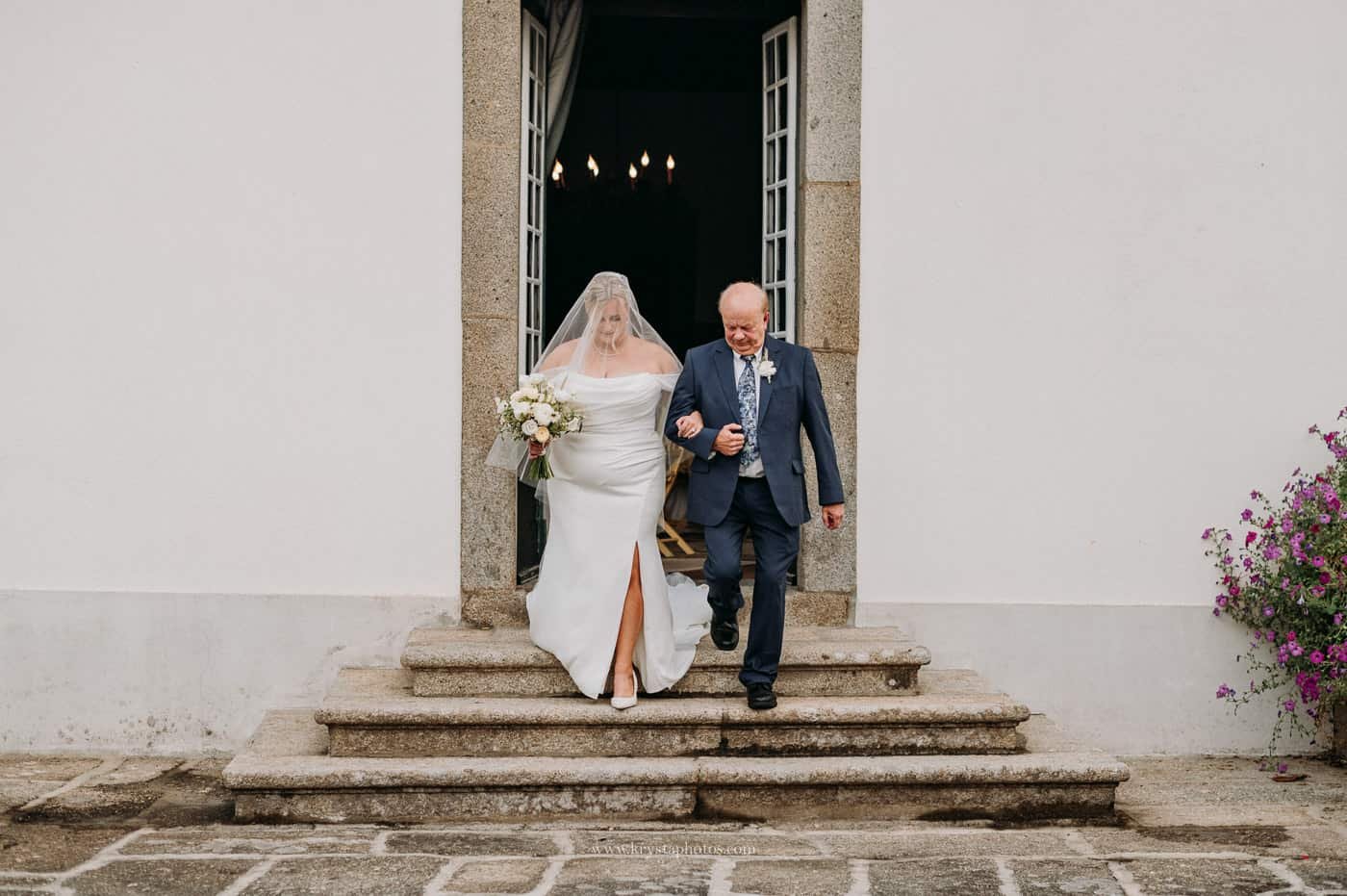 bride walking down the aisle with her father during a vineyard wedding in the Douro Valley Portugal