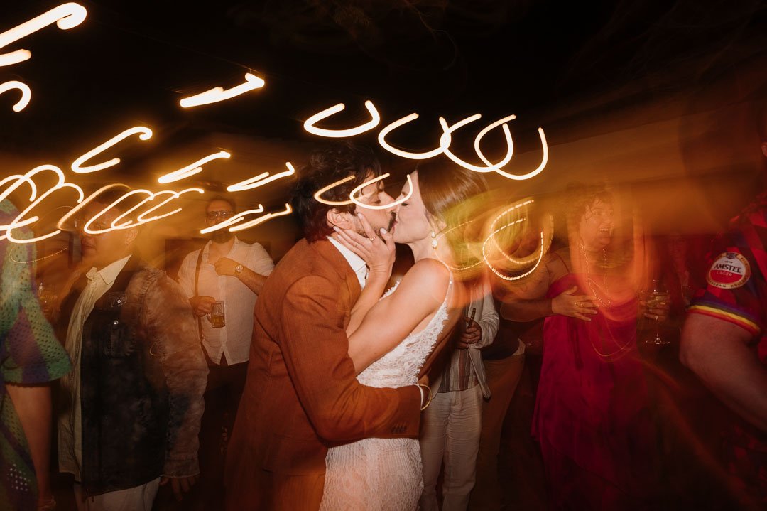 Boho chic wedding editorial detail with guitar and barefoot couple on vintage rug photographed by Portugal wedding photographer