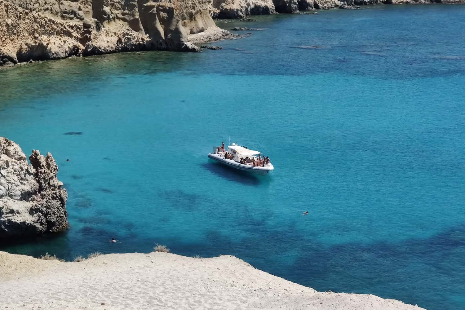 Couple strolling the narrow streets of Lemnos island, Greece being completely relaxed and enjoying summer holidays together.