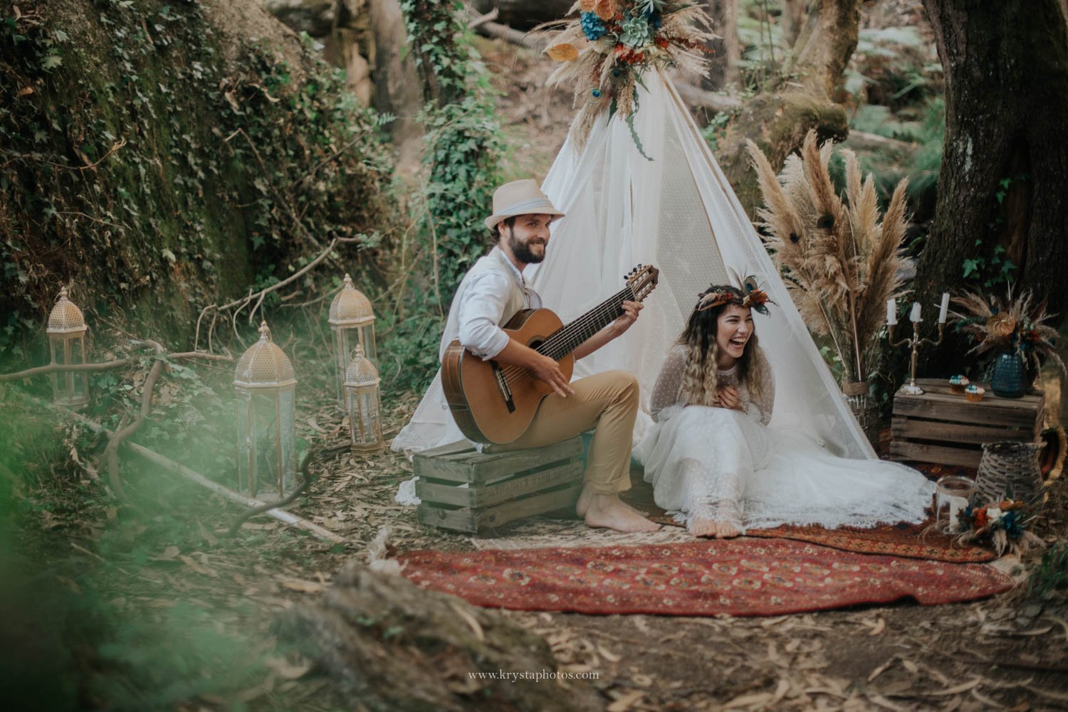 Boho chic wedding editorial scene in forest with couple, guitar and teepee photographed by Portugal wedding photographer