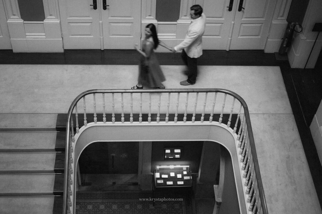 Well-dressed couple during Porto engagement photoshoot, iconic Porto streets and monuments, elegant dress and Prada bag, polished groom
