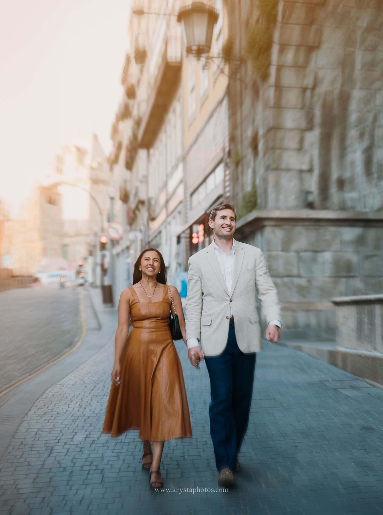Well-dressed couple during Porto engagement photoshoot, iconic Porto streets and monuments, elegant dress and Prada bag, polished groom