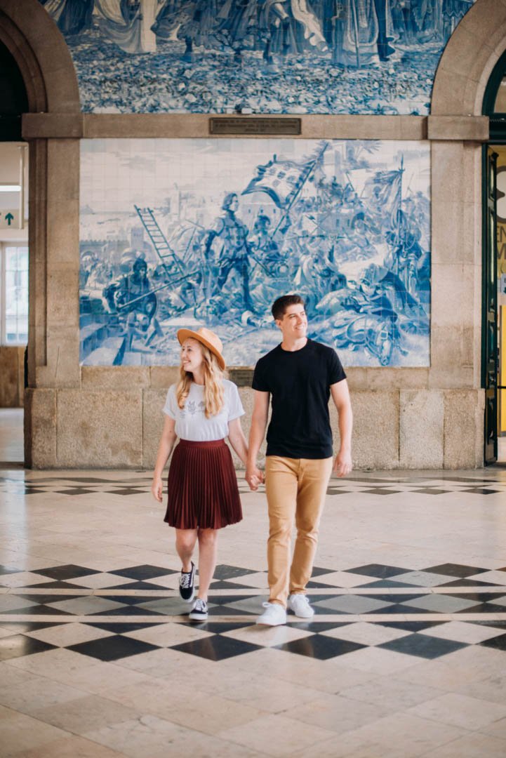 couple photoshoot at São Bento station Porto with azulejos and historic interior