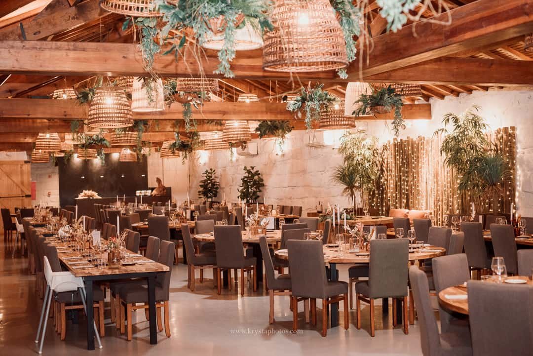 Rustic indoor wedding reception at Quinta do Avesso with stone walls, walnut wood ceiling, and romantic details