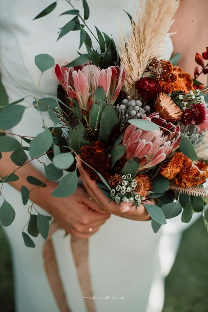 Rustic indoor wedding reception at Quinta do Avesso with stone walls, walnut wood ceiling, and romantic details
