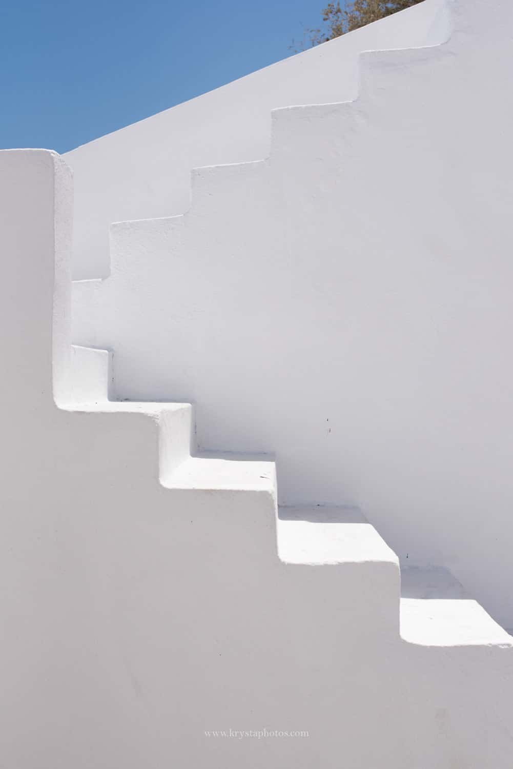Couple strolling the narrow streets of Lemnos island, Greece being completely relaxed and enjoying summer holidays together.