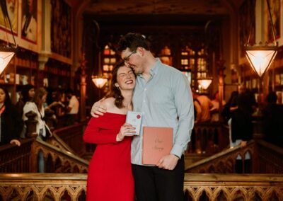 Surprise proposal at Livraria Lello in Porto on the iconic red staircase